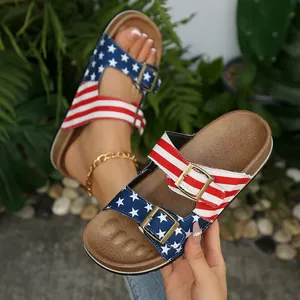 Close-up detail of American flag print sandals featuring adjustable antique bronze metal buckles