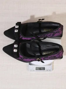 Detail view of purple lace pointed toe shoes with rhinestone bow weighing 467.9 grams