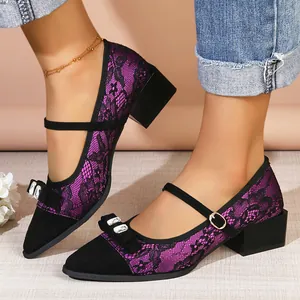Detailed view of elegant purple lace Mary Jane pumps with rhinestone bow and block heel