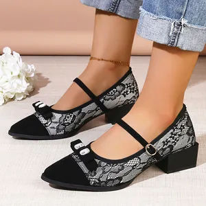 Detailed view of black lace pointed toe block heel pumps with rhinestone bow detail
