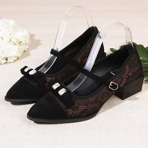 Elegant pointed-toe black Mary Jane shoes with lace details, a rhinestone bow and chunky heel.