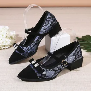 Elegant black lace Mary Jane pumps with pointed toe and crystal bow detail.