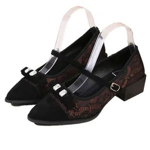 Elegant pointed-toe Mary Jane shoes with thick heels and shiny rhinestone bow detail.