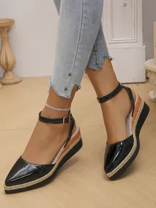 Close-up view of black patent leather wedge sandals with stylish rope-woven platform soles