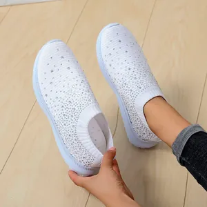 Detailansicht der weißen Mesh-Sneaker mit glitzernden Strasssteinen am Fuß getragen