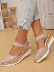Detail view of nude pointed-toe wedge sandals with espadrille rope sole and elastic strap