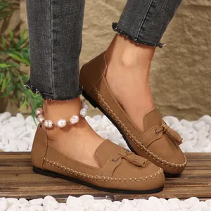 Close-up view of elegant brown tassel loafers with decorative stitching for women's daily wear