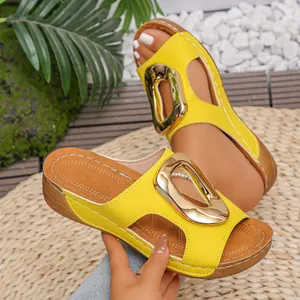 Women's yellow wedge sandals featuring a stylish gold metal buckle and open-toe design