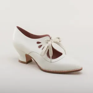Elegant white pointed toe high heel shoe with cutout petal design and lace-up bow