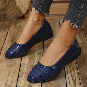 Detailed view of navy blue croc-embossed patent leather wedge shoes for women