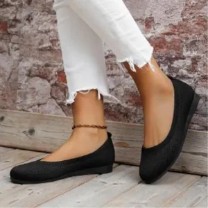 Detailed view of black knit flats for women featuring a soft sole and breathable mesh