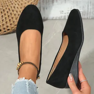 Close-up view showing the soft suede texture and stylish pointed toe of black wedge shoes