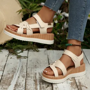 Detailed view of women's cream wedge sandals with platform sole and velcro strap