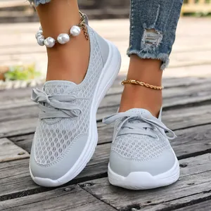 Close-up detail of light grey mesh breathable slip-on walking shoes for women outdoors