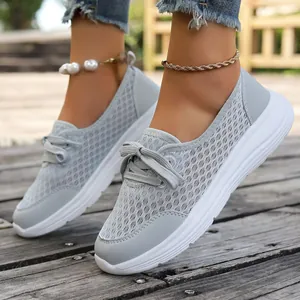 Macro view of light gray breathable mesh slip-on casual walking shoes for women