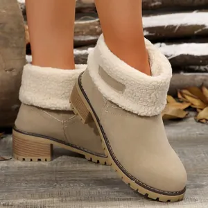 Detail view of beige winter ankle boots with cozy fleece cuff and chunky heel.