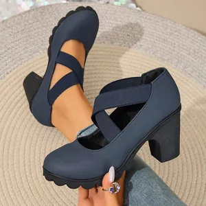 Retro navy blue Mary Jane pumps featuring thick block heels and cross elastic straps