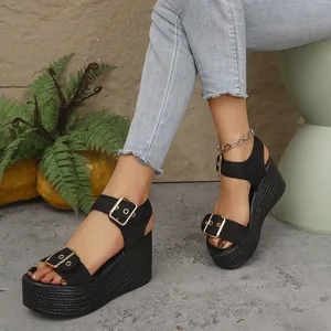 Stylish black wedge platform sandals with gold buckles and braided sole texture detail