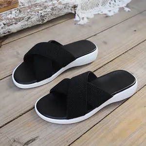 Detail view of black criss-cross woven straps on women's platform sandals.