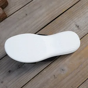 Detailed view of the white anti-slip wavy textured sole on thick platform slippers