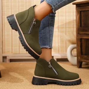 Side view of olive green suede ankle boots with side zipper and chunky lug sole.