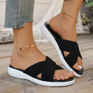 Women's black cross-strap platform slide sandals for summer wear.