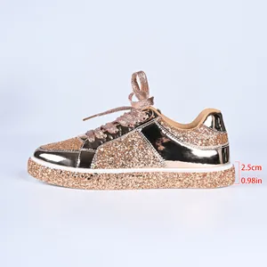 Close-up detail showing the 2.5cm platform height on these shiny gold sequined sneakers