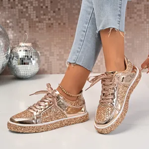 Detailed view of women's rose gold glitter platform sneakers with shiny metallic finish