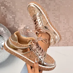 Detailed view of rose gold sequin platform sneakers with metallic finish and lace-up design