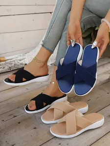 Close-up of comfortable women's platform sandals with criss-cross knit straps in various colors.