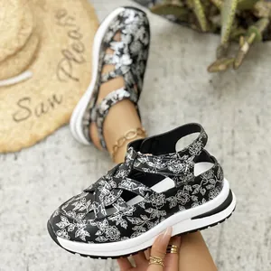 Close-up of black and white floral pattern on women thick-sole platform sandals
