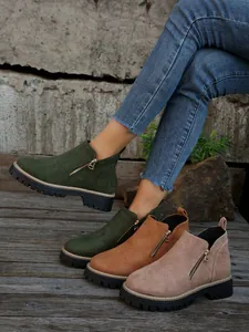 Detailed view of women's chunky sole ankle boots with side zippers in various colors