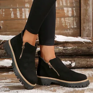 Black round-toe Martin boots with gold side zipper and thick lugged sole for women