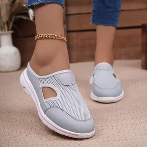 Close-up of breathable grey mesh slip-on mules with stylish pink platform sole accents
