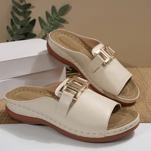 Elegant beige wedge sandals with gold buckle and peep toe design for women