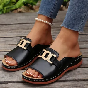 Casual women's black wedge sandals with elegant gold metal buckle and open toe design.