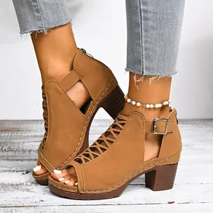 Detail view of tan chunky heel peep-toe sandals with elegant cutout straps and buckle