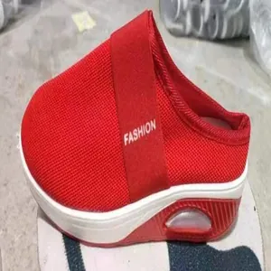 Detailed side view of women's red mesh mule sneakers featuring a thick air cushion sole