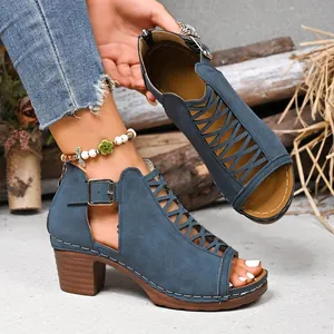 Detail view of blue faux-suede cutout gladiator sandals with chunky high heels