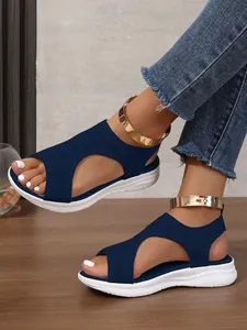 Dettaglio ravvicinato di sandali alla schiava blu navy con cinturino oro