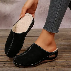 Black suede platform clogs for women with warm faux fur lining and white stitching