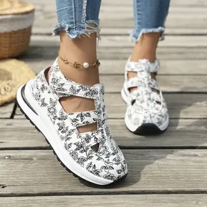 Detail view of women's floral sports sandals with thick white soles and velcro straps.