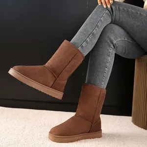 Close-up of brown suede snow boots worn with jeans for a warm winter look