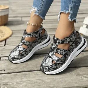 Close-up of floral print platform sandals for women on a wooden deck