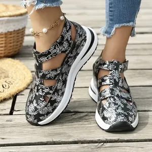 Detailed view of women's floral print platform sandals on wooden deck background