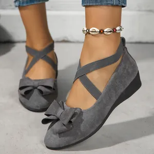 Elegant grey suede wedge shoes for women featuring stylish cross straps and a chic bow detail