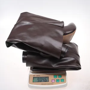 Dark brown leather pointed-toe boot weighing approximately 904 grams on scale