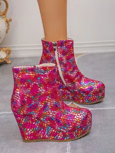 Close-up of colorful scale pattern on women's wedge platform ankle boots with side zipper