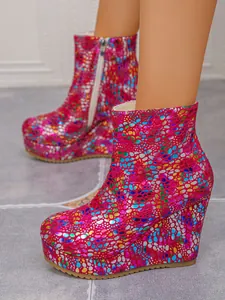 Detailed view of women's wedge platform ankle boots with vibrant multicolored pattern.