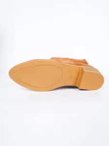 Detail view of the durable anti-slip sole and block heel of these brown suede fashion boots